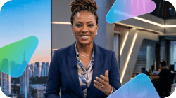 A smiling Black woman in a business suit in a modern TV studio.